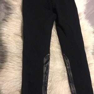 Black leggings with fake leather on the bottom.